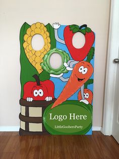 a cardboard sign that says logo here with vegetables and fruits on it in front of a door