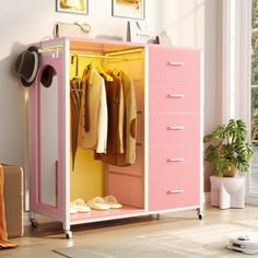 a pink and yellow cabinet with clothes hanging on it