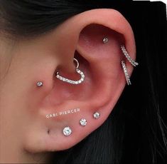 an ear with three different piercings on it