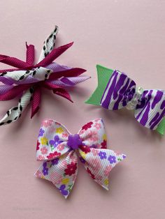 Three dog bows - one curly purple and black dog bow, one purple zebra dog bow and one floral dog bow Making Dog Hair Bows, Faux Leather Dog Bows, Puppy Hair Bows