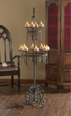 a candle holder with candles on it in front of a chair