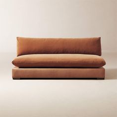 a brown couch sitting on top of a white floor