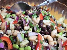 a salad with beans, carrots and onions in a bowl