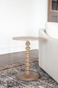 This contemporary pedestal table features a bold silhouette in modern matte black or natural finish. Handcrafted from solid mango wood with a veneer tabletop, this side table is both sturdy and durable. The turned pedestal base has a stacked round bead shape for a detail that makes a statement in updated traditional, modern or transitional homes. Place a table at each side of living room couch or in your home office by an occasional chair for the perfect spot to set down your cup of coffee or mo Spindle Side Table, Wood Pedestal Side Table, Spindle Leg Side Table, Pedestal End Table Rustic, Round Wood Pedestal Side Table, Transitional Homes, Pedestal Side Table, Living Room Couch, Staircase Decor