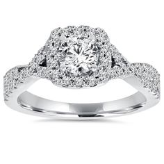 a white gold ring with diamonds on the band and an oval center stone surrounded by small round