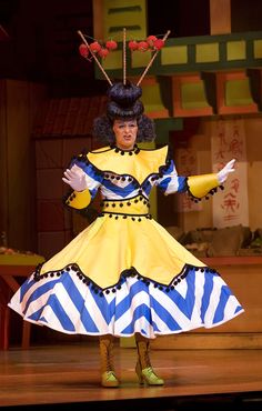 a woman in a costume standing on stage