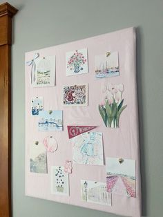 a pink bulletin board covered in pictures and magnets