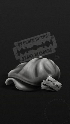 a black and white photo of a hat with two pieces of paper in front of it that says order of the peaky binders