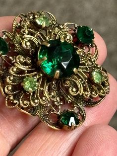 Vintage gold tone filagree work brooch,roll over clasp, set with claw set deep green crystal stones Green And Gold Jewelry, Vintage Jewellery Rings, Jewelry Board, Jewelry Boards, Crystal Stones, Green Crystal, Green Crystals, Vintage Costume Jewelry, Green Stone