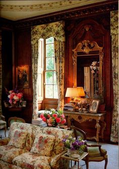 a living room filled with furniture and flowers