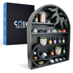 PRICES MAY VARY. UNIQUE SUN & MOON SHELVING: With the crescent moon and radiant sun built-in designs, this display shelf is perfect for anyone looking to add a touch of magic to their home. The endless rows of shelving and mini cubbies will create the perfect home to all your small trinkets and treasures. MULTIPURPOSE STORAGE SHELF: Our boho shelf is designed to hold a variety of small items including crystals, essential oils, small plants, candles and more! Take those treasured items out of sto Sun Moon Design, Spiritual Room Decor, Crystal Display Shelf, Spiritual Room, Essential Oil Shelf, Black Metal Wall Art, Crystal Shelves, Crystal Holder, Crystal Display