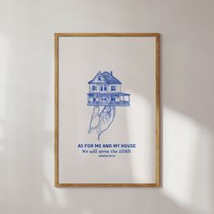 a blue and white poster hanging on the wall next to a wooden frame with a drawing of a hand holding a house