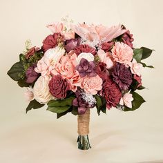 a bouquet of pink and purple flowers in a vase