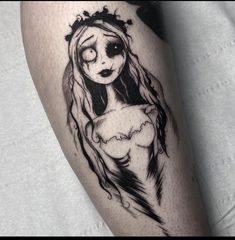 a woman with long hair wearing a crown tattoo on her leg