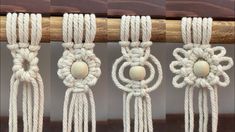 four different ropes with wooden beads on them