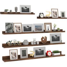 three wooden shelves with pictures and frames on them