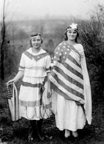 two women dressed in patriotic clothing standing next to each other