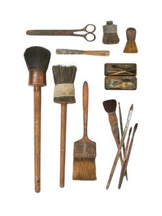 an assortment of tools including brushes, shaving brush, and other items on a white background