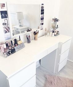 a white desk topped with lots of makeup