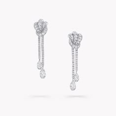 Pavé diamonds trace the contours of this petite yet powerful symbol of love in our Tilda’s Bow stud earrings. The white gold is sculpted by our master craftspeople to form a strong and graphic knot motif, tightly bound for unerring devotion. The Tilda’s Bow collection includes delicate pendants presented upon sleek chains, stud earrings and diamond rings, accompanied by larger high jewellery pieces that flaunt pear shape diamond drops. An exquisite pair of Tilda’s Bow pavé diamond earrings with Graff Jewelry, Diamond Drop Pendant, Classic Diamond Ring, Pear Shaped Diamond Ring, Diamond Drop Necklace, Pave Diamond Earrings, High Jewellery, Platinum Jewelry, Bow Jewelry