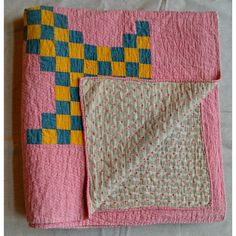 This is a wonderful early 20th-century meticulously hand-stitched summer-weight New England quilt in brightly colored yellow and blue squares on a red calico ground, and it also has a small geometric pattern on the back. The quilt pattern is a Triple Irish Chain. It has a great feel and can be used on a bed, displayed on a wall, or draped over furniture. It's nice on both sides.  Deirdre’s Bio: This comes from the archives of Deirdre Coughlin, founder of Phoebe’s Closet. She specializes in antiq Crossed Canoes Quilt, Quilt Squares Patterns, Yellow Brick Road Quilt, Triple Irish Chain, Small Geometric Pattern, Quilt Board, Hand Stitched Quilt, Irish Chain Quilt, Picnic Quilt