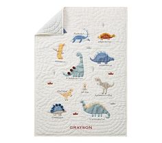 a baby quilt with dinosaurs on it and the words grayson written in red ink