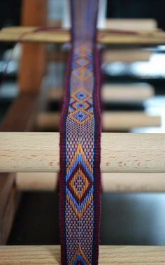 a close up view of a piece of cloth on a wooden table with other items in the background