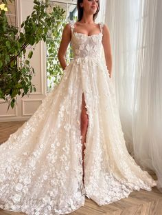 a woman in a white wedding dress standing next to a window with her legs high