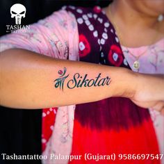 a woman with a tattoo on her arm that reads,'sitotar '