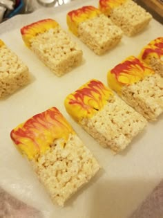 rice krispy treats with yellow and red swirled toppings on a baking sheet, ready to go into the oven