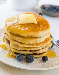 pancakes with butter and blueberries on a plate