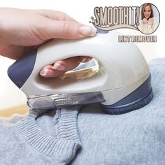 a person using an iron on top of a sweater