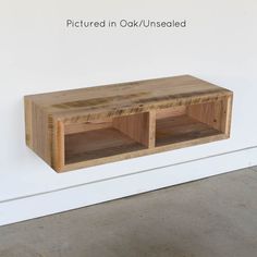 a wooden shelf sitting on the side of a wall next to a white wall with text that reads, pictures in oak / unsealed