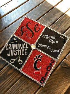 a close up of a graduation cap on a wooden surface