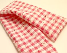 two pink and white checkered cloths with hearts on them are folded to show the pattern