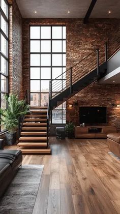 a living room filled with lots of furniture and large windows next to a stair case