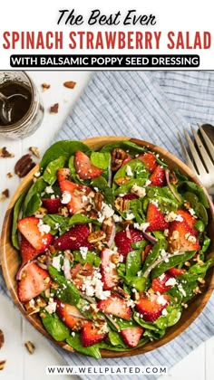 the best ever spinach strawberry salad with balsamic poppy seed dressing in a wooden bowl