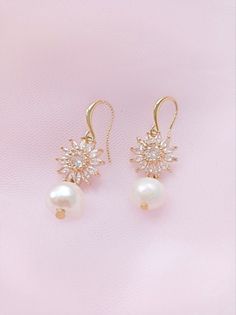 An elegant pair of cubic zirconia and pearl wedding earrings , adorned with freshwater pearls. Perfect jewelry to complete your wedding day look or to gift to bridesmaids Elegant Pearl Bridal Earrings With Pearl Chain, Elegant Pearl Chain Bridal Earrings, Elegant Pearl Dangle Earrings, Delicate Dangle Bridal Earrings With Pearl Pendant, Delicate Bridal Dangle Earrings With Pearl Pendant, White Dainty Cubic Zirconia Bridal Earrings, Dainty White Cubic Zirconia Bridal Earrings, Elegant Bridal Pearl Earrings With Charm, Elegant Gold Bridal Accessories With Cubic Zirconia