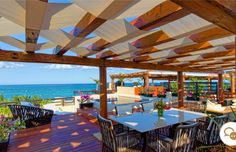 an outdoor dining area overlooking the ocean