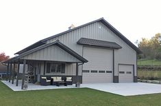 a large garage with a covered porch and attached seating area in front of the garage