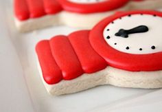 red and white decorated cookies with clocks on them