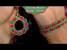 a close up of a person wearing christmas wreath beaded bracelets with red, green and gold beads