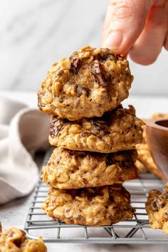 a stack of oatmeal cookies sitting on top of a cooling rack