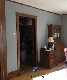 an empty room with a desk and chair in the corner, next to a closet