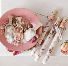 pink plate with spoons, salt and pepper shakers on it next to flowers