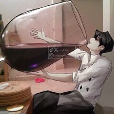 a person sitting on a table with a glass of wine in front of them,