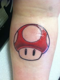 a small mushroom tattoo on the leg