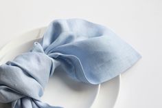 a white plate topped with a blue napkin