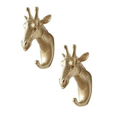 two gold giraffe head wall hooks on a white background with clippings