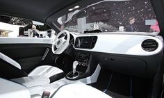 the interior of a car with white leather and black trim